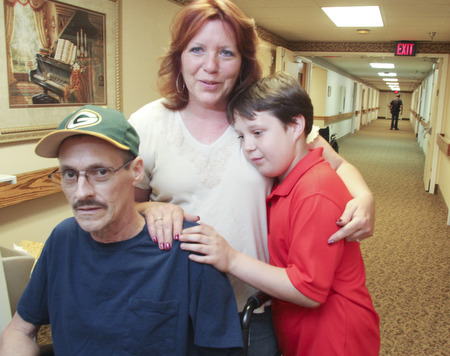 William D. Lewis\The Vindicator William D. Lewis\The Vindicator Russell Marshall of Berlin Center his son Jacob, 11, and wife Melissa Marshall in a hallway at Canterbury Villa in Alliance where Marshall is undergoing rehabilitation after a March farming accident..He lost his arm and suffered horrific injuries in the accident..