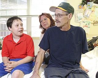 William D. Lewis\The Vindicator William D. Lewis\The Vindicator Russell Marshall of Berlin Center his son Jacob, 11, and wife Melissa Marshall at Canterbury Villa in Alliance where Marshall is undergoing rehabilitation after a March farming accident..He lost his arm and suffered horrific injuries in the accident..