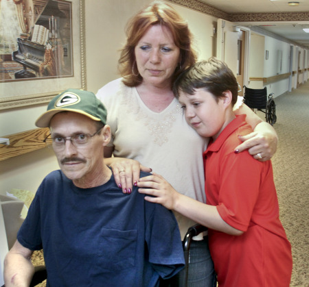William D. Lewis\The VindicatorWilliam D. Lewis\The Vindicator William D. Lewis\The Vindicator Russell Marshall of Berlin Center his son Jacob, 11, and wife Melissa Marshall in a hallway at Canterbury Villa in Alliance where Marshall is undergoing rehabilitation after a March farming accident..He lost his arm and suffered horrific injuries in the accident..