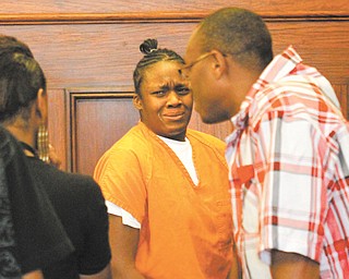 Khadijah Payden-Briggs, center, breaks down in tears with her family looking on as she leaves the courtroom of Judge John M. Durkin of Mahoning County Common Pleas Court.