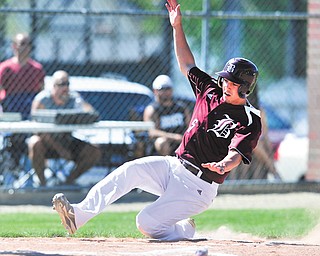 Boardman’s Nico DiIanni slides into home to score the Spartans’ first run of their Division I sectional final against Warren Harding on Thursday in Warren. The Spartans ousted the Raiders, 20-3.