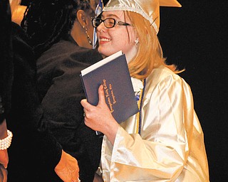 Nicole Miller smiles after receiving her high school diploma during Youngstown Early College commencement.
Miller also is one of 10 of the 47 graduates who earned an associate degree from YSU’s College of Liberal Arts
and Social Sciences on Saturday.