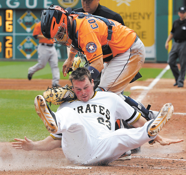 Pirates baserunner Travis Snider, bottom, rolls into Astros catcher Jason Castro after being tagged out trying to score from second on a single by Gaby Sanchez in the sixth inning of Sunday’s game at PNC Park in Pittsburgh.