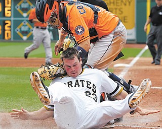 Pirates baserunner Travis Snider, bottom, rolls into Astros catcher Jason Castro after being tagged out trying to score from second on a single by Gaby Sanchez in the sixth inning of Sunday’s game at PNC Park in Pittsburgh.