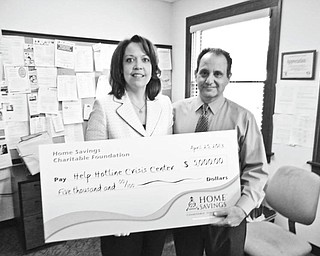 SPECIAL TO THE VINDICATOR

Home Savings Charitable Foundation has donated $5,000 to Help Hotline Crisis Center to help fund its 24/7 hotline. Trish Mohan is branch manager of Home Savings’ main office, and Duane J. Piccirilli is CEO of Help Hotline Crisis Center. For 
information about Help Hotline call 330-747-5111 or visit 
www.helphotline.org/home.
