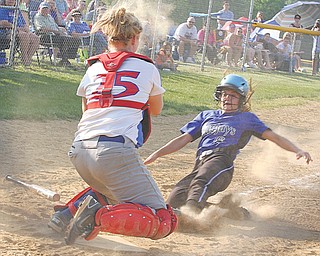 Western Reserve catcher Marley Oles blocks the plate as Jackson-Milton’s Zaina Sahli tries to score during a Division IV softball semifinal Monday in Lisbon. The Bluejays ousted the Blue Devils, 8-5, and advance to the
final against Mineral Ridge.