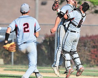 Struthers’ Dan Diloreto (2) goes to join Wildcat pitcher Gary Muntean (24) and catcher Brandon Kish (5) as they celebrate the final out in the seventh inning of a Division II baseball semifinal against Niles on Monday at Cene Park in Struthers. The Wildcats ended the Red Dragons’ season with a 6-3 win.