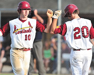 Cardinal Mooney’s Drew Beck (10) is congratulated by Ryan Megyesi (20) after scoring a run in the top of the second inning against Struthers on Tuesday.
