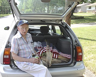 William D. Lewis\The Vindicator Meter Fromel,85, takes a break while helping Austint NS students placing flags along streets in Austintown.