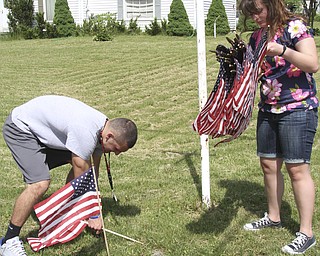 William D. Lewis\The Vindicator
Austintown NHS members Camran Rezapourian and Lynnette Seebacher place flags at Edinburg and Ayrshire in Austintown.