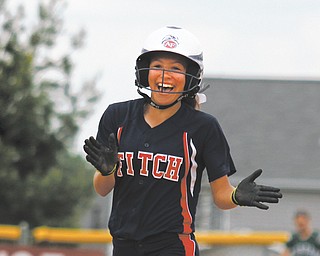 Fitch’s Cali Mikovich is all smiles as she rounds the bases after hitting a two run home run against Aurora in the Division I district softball championship Wednesday at the Fields of Dreams in Boardman. The Falcons ousted the
Greenmen, 5-2.
