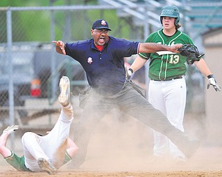 Ursuline batter Sam Donko (13), right, watches as the home plate umpire calls teammate Ryan Strollo out
after Strollo attempted to score on a passed ball during the Division III district baseball championship against South Range on Wednesday at Cene Park in Struthers. The Irish downed the Raiders, 12-1.