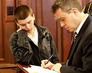ROBERT K. YOSAY | THE VINDICATOR
Atty Walter Richie fills in the paperwork as Ashley Shubert - watches after sentencing in Judge Durkins Court
26-year-old Warren woman is headed to prison for the next three years over sexual activity with a minor girl she befriended in 2012.
Ashley Shubert of Niles Road appeared for sentencing Thursday before Judge John M. Durkin of Mahoning County Common Pleas Court on one count of rape and two counts of felony gross sexual imposition.