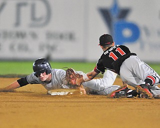 Fitch’s Luke Peterson avoids the tag by Chardon infi elder Mason Bender to reach second base on a steal during their Division I district semifinal baseball game Thursday at Cene Park in Struthers. After three rain delays, the Falcons ousted the Hilltoppers, 6-2.