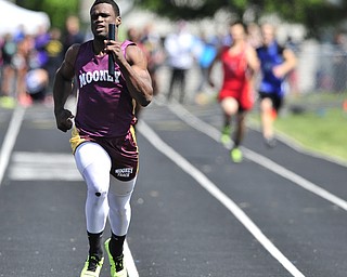 Mooney runner Marcus McWilson breaks away from the pack during the final stretch of the boys 4x200 meter relay. 