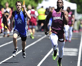 Mooney runner Marcus McWilson pulls away from Lakeview runner Ben Biehl during the final leg of the boys 4x100 meter relay.