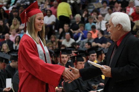 .IMG 9268: ÊAshley Hefferon (left) shakes hands with Board of Education president Ron Carcelli before receiving her diplomaÊduring commencement at the Struthers Field House on Sunday. ÊDustin Livesay Ê| ÊThe Vindicator Ê5/26/13 ÊStruthers High School. Ê