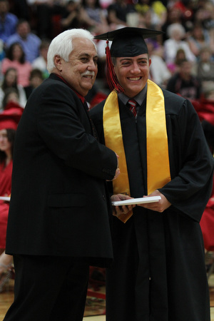 .IMG 9307: ÊAnthony Lariccia poses for a picture withÊBoard of Education president Ron CarcelliÊduring commencement at the Struthers Field House on Sunday. ÊDustin Livesay Ê| ÊThe Vindicator Ê5/26/13 ÊStruthers High School. Ê