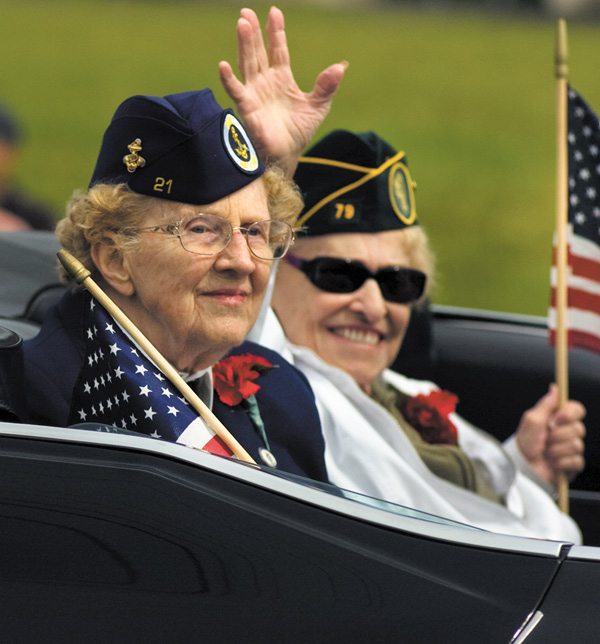 Nan Reeveley, front, and Florence Pearl, both of Boardman, ride in the North Coast WAVES Unit 21 car, waving to spectators during the Memorial Day Parade in Boardman.
