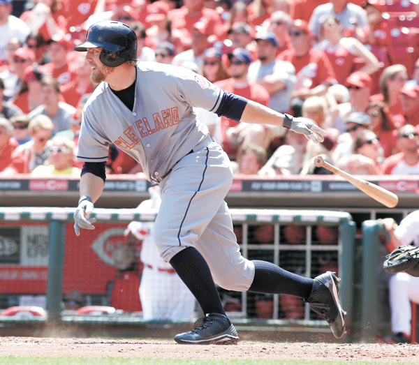 Cleveland Indians’ Mark Reynolds hits a single during a game against the Cincinnati Reds on Monday in Cincinnati.
