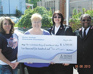 SPECIAL TO THE VINDICATOR
Home Savings Charitable Foundation has donated $2,500 to the Salvation Army of Northeast Ohio to support the emergency food program in East Liverpool. From left are Megan Bennett, office administrator/case manager, Salvation Army; Judy Smit, senior branch manager, Home Savings; and Majs. Stella McGuire and Douglas McGuire, pastors, Salvation Army. Federal funds and private donors support the emergency food program. For 
information on the Salvation Army of Northeast Ohio call 216-861-8185 or visit www.use.salvationarmy.org.
