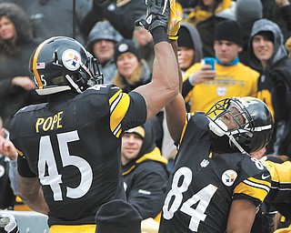 Pittsburgh Steelers wide receiver Antonio Brown (84) and tight end Leonard Pope (45) celebrate after Brown made a touchdown catch in the third quarter of a football game against the Cleveland Browns in Pittsburgh.