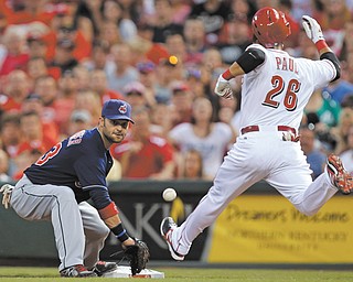 Cincinnati Reds’ Xavier Paul (26) arrives at first with an infield hit as Cleveland Indians first baseman Nick Swisher awaits the throw in the fifth inning of a baseball game Tuesday in Cincinnati.