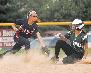 Austintown Fitch’s Cali Mikovich, left, tags Aurora’s Nicole Doyle out at third base during a Division I tournament game on May 22 at Fields of Dreams in Boardman. The Falcons’ 5-2 victory clinched their first regional berth since 2005. Fitch will meet Medina in a regional semifinal at 5 p.m. Thursday at the University of Akron.