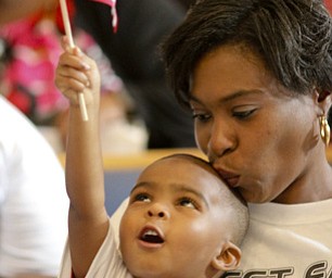 William D Lewis the Vindicator  Kimberly Glenn kisses her grandson Xavier Simms, 3, during a anti violence rally at New Bethel Baptist Church in Youngstown 5-29-12. Family members of violence victims remembered the deceased during the event. Glenn and her grandson were with a large group of family and friends remembering Carlos Crues who was killed 1-28-12.