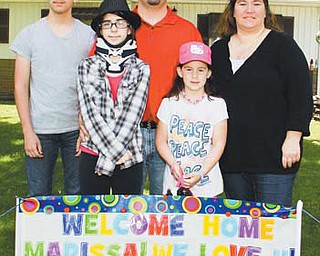 Edward, Marissa, Ed, Mary Anne and Anne Marie Salus pose for a picture behind a “Welcome Home” sign set up for 12-year-old Marissa when she returned from the Cleveland Clinic after nearly three weeks and two surgeries to treat her chordoma.