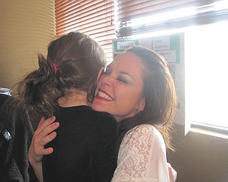Harper Liller, 5, hugs her mother, Terri Liller, at the Blue Wolf Tavern during the 50th wedding anniversary of Harper's grandparents, Ralph and Sandy. Photo taken by Matt Liller of Boardman, Harper's dad and Terri's husband.