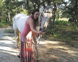 Amity McFarlin of Paradise, Texas, granddaughter of recently deceased Youngstown resident Dorothy Clark, hugs Rascal. Photo sent in by Sherry Parent of Youngstown.