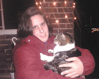 Alison Stanislaw of Youngstown hugs Tagger the neighborhood cat. Photo sent in by Sherry Parent of Youngstown.