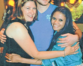 Heidi VanAuker, left, gives a hug to her son, Aaron Hartsough, a YSU junior, and Alyssa Harrison, a YSU student. Photo submitted by Lana VanAuker of Canfield.