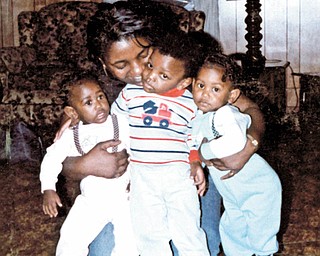 Carol and Marcus Thomas and twins Michelle an Michael Pete, all of Youngstown, share a group hug. Photo sent by Othella May of Youngstown.