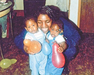 Carol Thomas puts the squeeze on twins Michelle and Michael Pete, all of Youngstown. Othella May of Youngstown sent this photo.