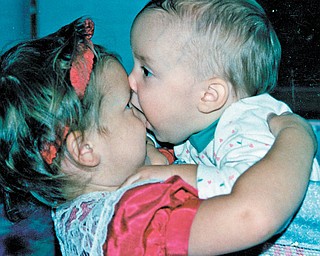 Ann Michelle Jesko, 3, gets a little more of a hug than she probably bargained for from Carolyn Leigh Jesko, 1. Photo sent in by Gramma Sophia Juruaz of Youngstown.