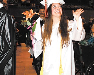 Selina Nuzzi waves as she leaves the stage area with her classmates after commencement ceremonies ended for
Howland High School on Thursday night at Packard Music Hall.