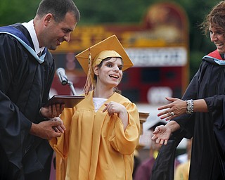 MADELYN P. HASTINGS | THE VINDICATOR

David Malone and Michele Stewart present a diploma to Paige Goodman (center) as she walks across the stage during Liberty High School's commencement.