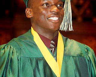 MADELYN P. HASTINGS | THE VINDICATOR
Khallid Pierce walks across the stage after receiving his diploma during Ursuline High School's commencement on June 2, 2013 in Stambaugh Auditorium.