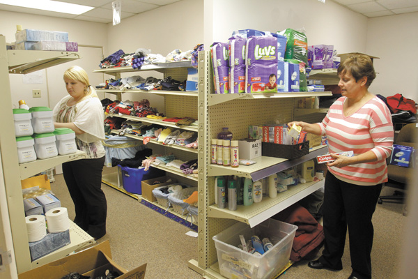 Sarah Luzik , left, and Nancy Voitus , executive director of Catholic Charities Regional Agency that serves Columbiana, Mahoning and Trumbull counties, take inventory at Harriet’s Cupboard, which provides personal-hygiene products, cleaning supplies and paper products for those in need. Harriet’s Cupboard was named in memory of the late Harriet Labedz , who worked at CCRA for 28 years.