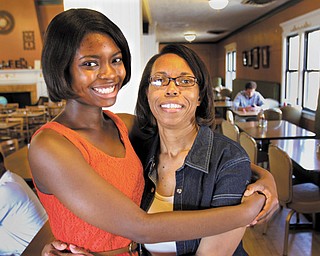 Warren G. Harding High School graduate Taylor Stephenson will attend Youngstown State University this fall on a full-ride scholarship, including room and board. Her mother, Billie Bradley, getting a hug inside of Warren’s Mocha House, agrees she could not have afforded to send her daughter to college without the Academic Achievers program.