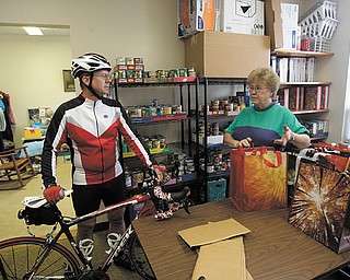 Don Cherry, a bicycling enthusiast and member of Grace United Methodist Church in Warren, talks to Shirley Frazier, the church’s food-pantry coordinator, about his upcoming 68-mile bike ride that is a fundraiser for the pantry.