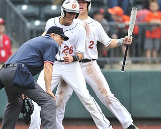 Wheelersburg baserunner #26 Wade Martin is congratulated by teammate #2 Camron Parsley after scoring the go ahead run in the top of the 8th inning. 