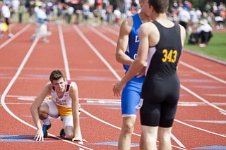 Andrew O'Leary stumbles to his knees after competing in the 400m dash at the state track and field finals at Jesse Owens Memorial Stadium, Columbus, OH, Saturday, July 8, 2013.