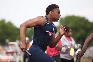 A member of the Austintown-Fich 4x200m relay team competes in the event at the state track and field finals at Jesse Owens Memorial Stadium, Columbus, OH, Saturday, July 8, 2013.