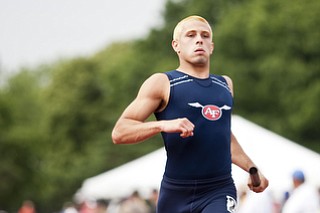 A member of the Austintown-Fich 4x200m relay team competes in the event at the state track and field finals at Jesse Owens Memorial Stadium, Columbus, OH, Saturday, July 8, 2013.