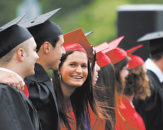 Stephanie Carrocce smiles while singing the alma mater during Canfield High School’s commencement exercises Sunday afternoon at the school’s football stadium.