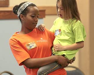 ROBERT K. YOSAY | THE VINDICATOR
Helping hand as Eliza Farr 7 gets a lift from counselor Haben Voorhies as they move from the craft area to the music area
the Downtown Mission’s Children’s Art Camp, currently under way at St. Columba Cathedral parish hall about 25 participants enjoy the activities.
