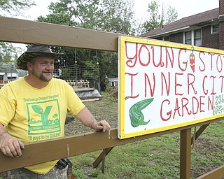 William D. Lewis\The Vindicator
Mason Carratt stands near his garden on Hillman in Youngstown 6/10/13 He has cleaned up a vacant trash filled lot and planted a garden where he plans to offer produce to those in need.